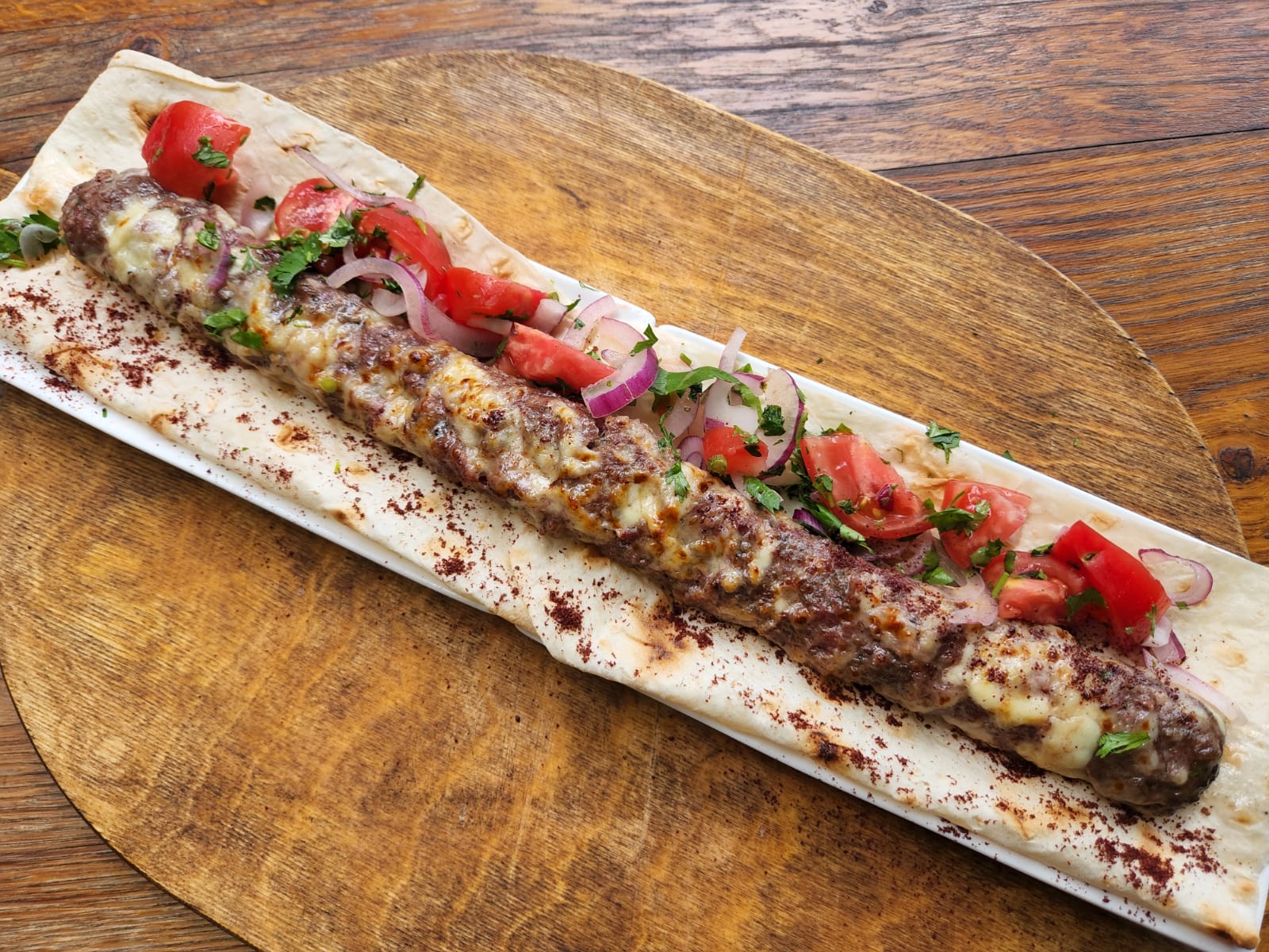 Branded Kebab with beef and sulguni - Georgian dish at Tbilisuri Ezo restaurant in Tbilisi }}
