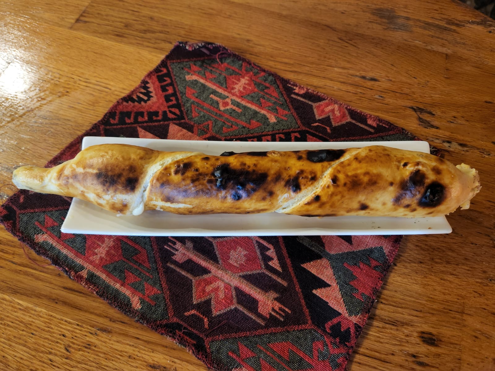 Khachapuri on a skewer - Georgian dish at Tbilisuri Ezo restaurant in Tbilisi }}