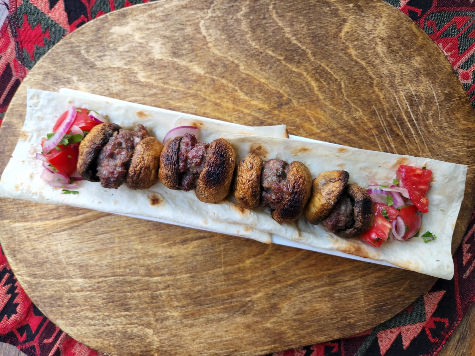 Beef kebab with mushrooms - Georgian dish at Tbilisuri Ezo restaurant in Tbilisi }}